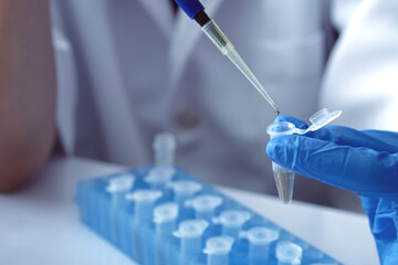 scientist using auto-pipette with Eppendorf consumables tube in the lab , Doing experiment for product, The researchers analyzed to find the results of the experiment.