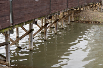 Scenery under a wooden bridge over the river