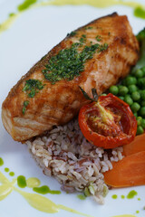Salmon steak with side dish and baked vegetable