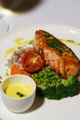 Salmon steak with side dish and baked vegetable