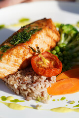 Salmon steak with side dish and baked vegetable