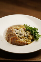 Pasta with chicken fillet , mushrooms and parmesan cheese