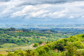 Fototapeta na wymiar Tuscan countryside landscape with rain clouds