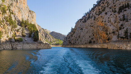 Double water footprints from a boat on the water in Green Canyon in Turkey