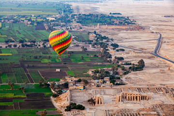 Aerial view of beautiful hot air balloon flying over the ruins Temple of the Ramesseum.