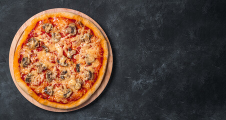 Juicy pizza with tomatoes, mushrooms, cheese and tomato sauce on a board on a dark background.