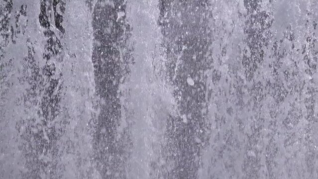 Closeup of water spurting from the fountain. Water jet splashing. 4K