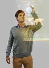 Photo manipulated shot of a young man using a theoretical digital interface..All screen content is designed by us and not copyrighted by others, and upon purchase a user license is granted to the