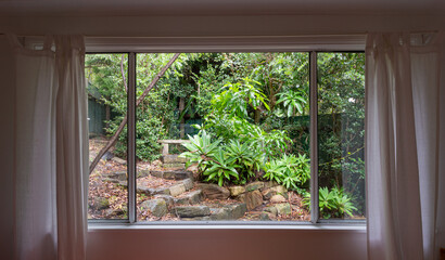 looking out a window to a green garden