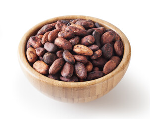 Uncooked cacao beans in wooden bowlisolated on white background with clipping path