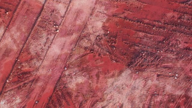 Aerial top view of red muck on construction site