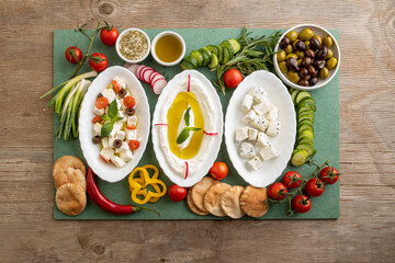 Closeup of Labneh, Greek cheese with veggies and Cheese with Fennel flower seeds and veggies;...