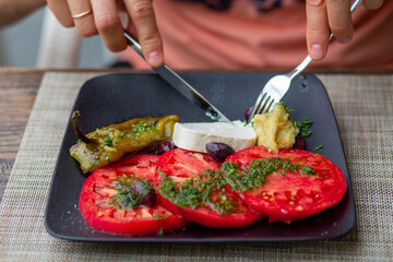 Proper nutrition salad. Delicious colorful salad with tomato and cheese. Buffalo cheese with tomatoes. Healthy lifestyle. Delicious and healthy food. Tomato salad with olives. Diet. Salad without meat