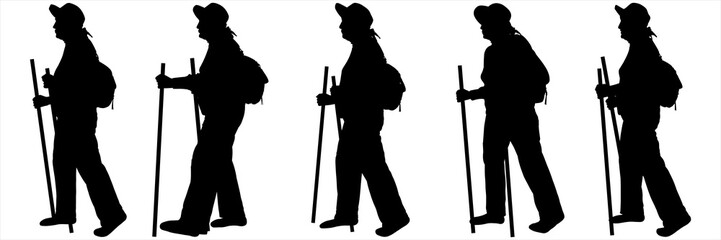 A woman with a backpack on her back, a hat on her head, and hiking sticks in her hands. Travel in retirement. Women walk one after another in one line. Hiking. Sport. Tourists on a hike. Side view.