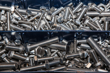 Bolts, nuts and washers in a box close-up.