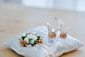 gold wedding rings with a pattern on a white cushion