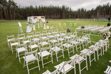 football field wedding ceremony white chairs