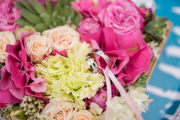 gold wedding rings with precious stones on a floristic box