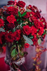 red floral arrangement in a vase of roses and carnations