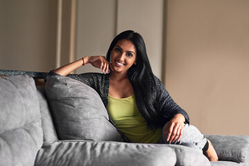 Obraz premium In my comfort zone. Portrait of an attractive young woman sitting on her sofa at home.
