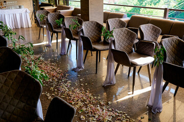 path of rose petals at a wedding among chairs at a ceremony