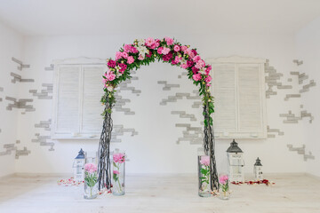 arch of peonies wedding floristry white walls