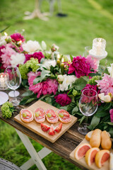 buffet table in the open air decorated with floristry