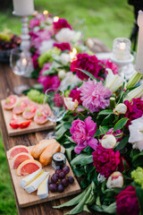 buffet table in the open air decorated with floristry