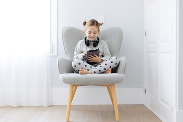 Girl with headphones using the tablet