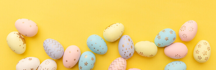 Easter colorful eggs on a yellow background. Top view. Easter card