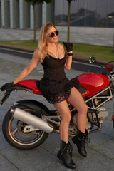 Foto op Plexiglas Blonde biker and red colored motorcycle outdoors © Fxquadro