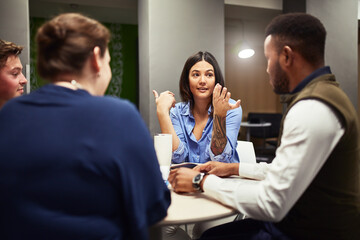 She has a breakthrough idea. Shot of a group of designers having a meeting in an office.