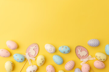 Easter colorful eggs on a yellow background with copy space. Top view. Easter card