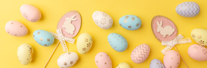 Easter colorful eggs on a yellow background. Top view. Easter card