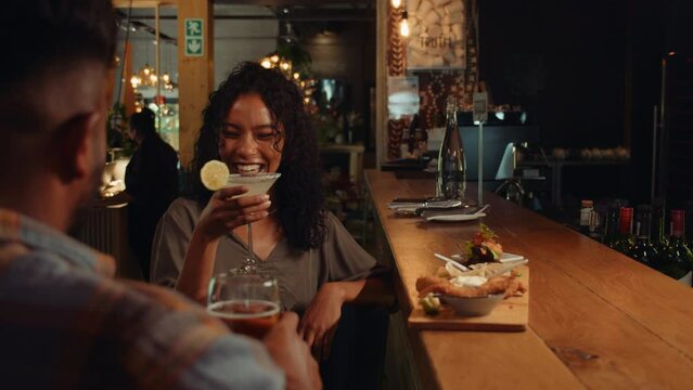 African American couple drinking cocktails at the bar