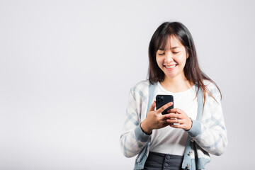 Woman excited read social network feedback on smartphone studio shot isolated white background, young female smiling typing sms message on mobile phone in social media