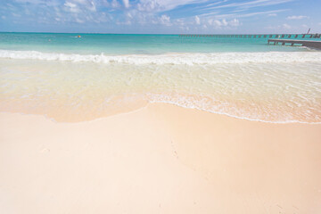 Fototapeta na wymiar Cancun Mexico beautiful caribbean sea on a sunny day and cloudy sky. sandy beach