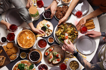 Group of people having brunch together at table indoors, top view