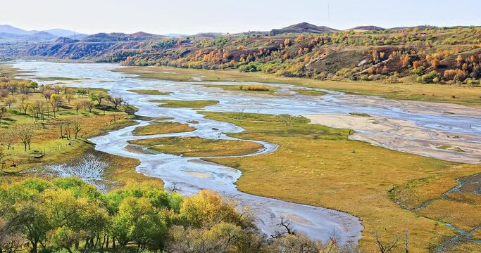Beautiful river and sandy beaches in Inner Mongolia, China. River and mountain with forest in autumn. 4K real time footage.
