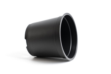 small black plastic pot for indoor flowers on a white background. accessories for seedlings of plants at home.