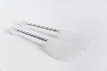Flexible plastic spring mold holders for shoes on a white background. to preserve the shape of leather shoes and sneakers during natural drying and storage.