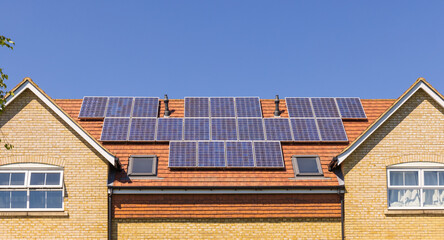 Solar panels on the roof of a new build home. UK.
