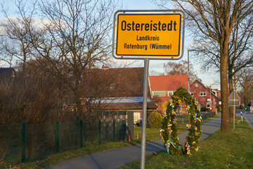 location sign of Ostereistedt, Germany with a large Easter Egg in background