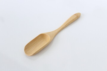 Empty wooden scoop isolated on a white background.