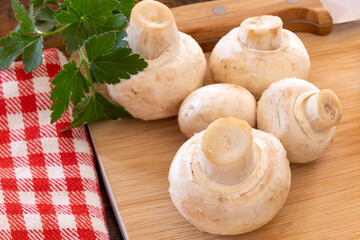 fresh whole mushrooms on the wooden board
