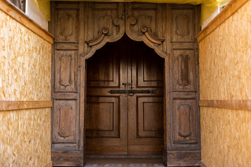 old wooden door at the construction site of an antique building