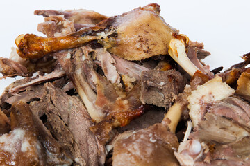 Sliced baked duck at home close-up on a white background.
