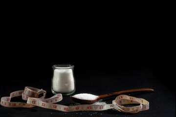 Waist tape, brown Spoon of white sugar on a black background