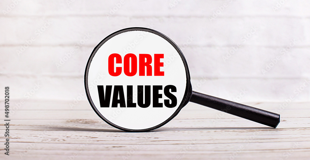 Poster the magnifying glass stands vertically on a light background with the text core values