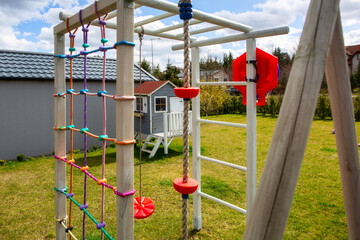 Fototapeta na wymiar Garden playground for children with a climbing wall